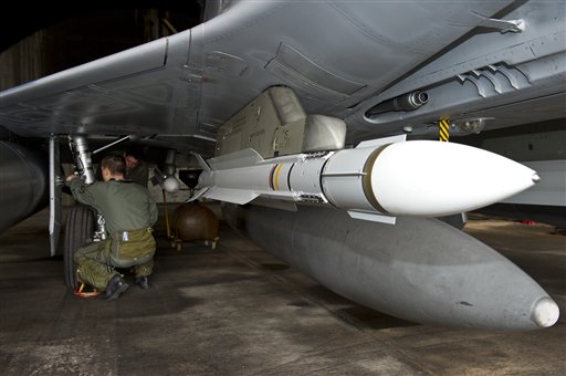 This photo provided by the French Army shows a pilot checking a French Mirage 2000 jet fighter at the military base of Dijon, central France, Saturday, March 19, 2011. Top officials from the United States, Europe and the Arab world have launched immediate military action to protect civilians as Libyan leader Moammar Gadhafi's forces attacked the heart of the country's rebel uprising. The Mirages 2000 are operating in Libya. (AP Photo/ Anthony Jeuland; SIRPA AIR) NO SALES (AP)