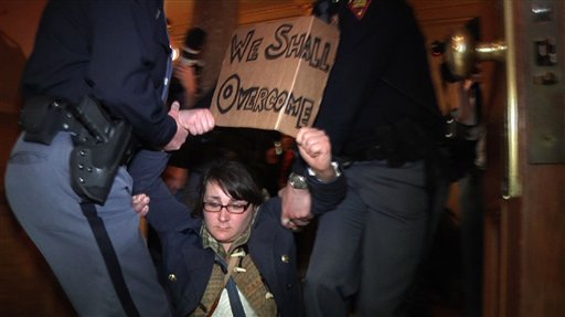 In this image from video, police carry off a demonstrator during a protest at the State Capitol, Thursday, March 10, 2011, in Madison, Wis. Police carried dozens of protesters from a hallway leading to the Wisconsin Assembly on Thursday as Democratic representatives pounded on the locked door of the chamber, demanding to be let in to the room where a vote was scheduled on an explosive bill that would take away public workers' collective bargaining rights.  (AP Photo/Robert Ray) (AP)