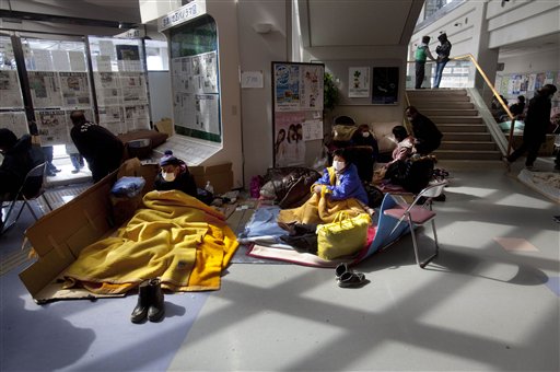 Japanese refugees sit inside a community center made into a shelter in the earthquake and tsunami-hit town of Minamisanriku, Friday, March 18, 2011.  (AP Photo/David Guttenfelder) (AP)