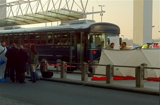 Police surround a bus carrying U.S. soldiers at the site where two US soldiers have been killed in a shooting in front of Terminal 2 of the Frankfurt airport, Germany, Wednesday, March 2, 2011. (AP Photo/dapd, Alexander Becher) (AP)