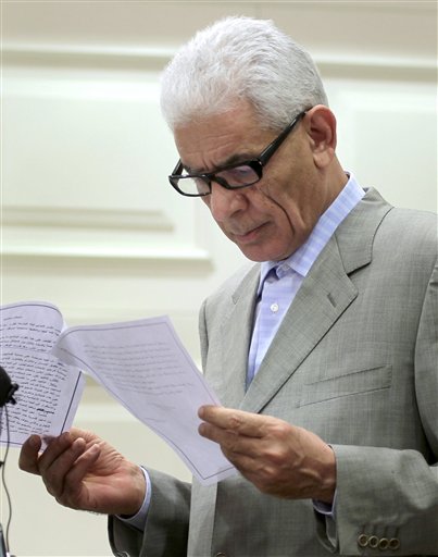 Libya's Foreign Minister Moussa Koussa  reads a statement to foreign journalists at a hotel in  in Tripoli, Friday March 18, 2011. We decided on an immediate ceasefire and on an immediate stop to all military operations," he told reporters. "(Libya) takes great interest in protecting civilians," he said, adding that the country would also protect all foreigners and foreign assets in Libya. The U.N. Security Council  voted early Thursday evening on a resolution that imposes a no-fly zone and  also authorize U.N. member states to take "all necessary measures" to protect civilians from attacks by Muammar Qaddafi's forces.(AP Photo/Jerome Delay) (AP)