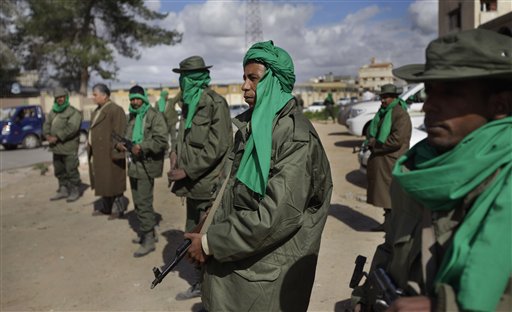 Unidentified pro-Gadhafi security forces stand near a checkpoint on a street in Qasr Banashir, southeast of the capital Tripoli, in Libya, Tuesday, March 1, 2011. Government opponents in rebel-held Zawiya repelled an attempt by forces loyal to Moammar Gadhafi to retake the city closest to the capital in six hours of fighting overnight, witnesses said Tuesday. (AP Photo/Ben Curtis) (AP)