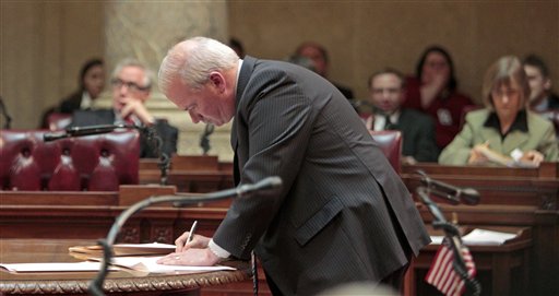 Wisconsin Senate Majority Leader Scott Fitzgeral, R-Juneau, signs orders finding the 14 missing Democrats in contempt, at the state Capitol in Madison, Wis., Thursday, March 3, 2011, . (AP Photo/Andy Manis) (AP)