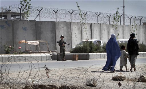 An Afghan solider, center, stands guard  outside of the main prison in Kandahar, south of Kabul, Afghanistan Monday, April 25, 2011.  Taliban insurgents dug a more than 1,050-foot (320-meter) tunnel underground and into the main jail in Kandahar city and whisked out more than 450 prisoners, most of whom were Taliban fighters, officials and the insurgents said Monday. (AP Photo/Allauddin Khan) (AP)