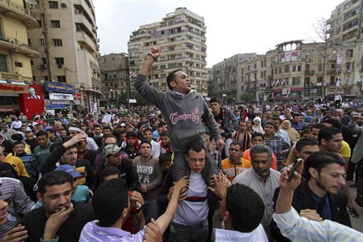 Protesters chant slogans as they march following an attack by security forces in Tahrir Square, in Cairo, Egypt, Saturday, April 9, 2011. Demonstrators burned cars and barricaded themselves with barbed wire inside a central Cairo square demanding the resignation of the military's head after troops violently dispersed an overnight protest killing one and injuring scores. (AP Photo/Khalil Hamra) (AP)
