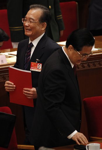 Chinese Premier Wen Jiabao, left, walks next to Chinese President Hu Jintao after the closing session of the annual National People's Congress in Beijing's Great Hall of the People, China, Monday, March 14, 2011. (AP Photo/Vincent Thian) (AP)