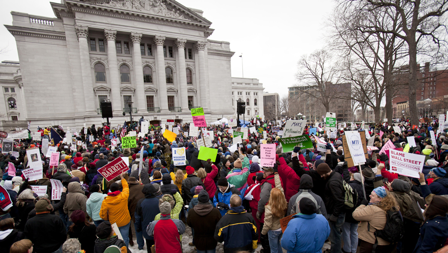 Crowds listen as Michael Moore makes a speech at the state Capitol in Madison, Wis., Saturday, March 5, 2011, on the 18th day of protests over the governor's proposed budget that would eliminate collective bargaining rights for many state workers. (AP Photo/Andy Manis) (Andy Manis)