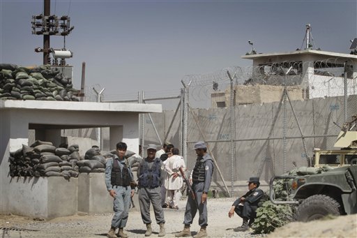 Afghan policemen stand in front of gate of the main prison in Kandahar, south of Kabul, Afghanistan on Monday, April 25, 2011. Taliban insurgents dug a more than 1,050-foot (320-meter) tunnel underground and into the main jail in Kandahar city and whisked out more than 450 prisoners, most of whom were Taliban fighters, officials and the insurgents said Monday. (AP Photo/Allauddin Khan) (AP)