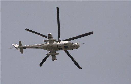 A UN helicopter pass over the city of  Abidjan, Ivory Coast, Friday, April 1, 2011.Heavy fighting raged Friday near Ivory Coast's presidential palace and mansion and the state TV broadcaster as armed forces loyal to the elected leader tried to install him to power and oust the country's strongman. (AP Photo/Emanuel Ekra) (AP)