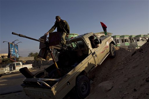 Libyan rebel fighters take positions in the besieged city of Misrata, Libya, Wednesday, April 27, 2011. NATO warplanes pounded forces loyal to Libyan leader Moaamar Gadhafi attacking the rebel-held city of Misrata, blasting fighting vehicles advancing on the port that serves as the besieged city's sole lifeline, a NATO spokeswoman said on Wednesday. (AP Photo/Bernat Armangue) (AP)