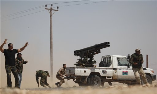 Libyan rebels fire a rocket launcher toward pro-Gadhafi forces along the front line near Brega, Libya Tuesday, April 5, 2011. Libyan government forces on Tuesday unleashed a withering bombardment of the rebels outside a key oil town pushing them back, even as the regime said Moammar Gadhafi might consider some reforms but would not stepping down. (AP Photo/Nasser Nasser) (AP)