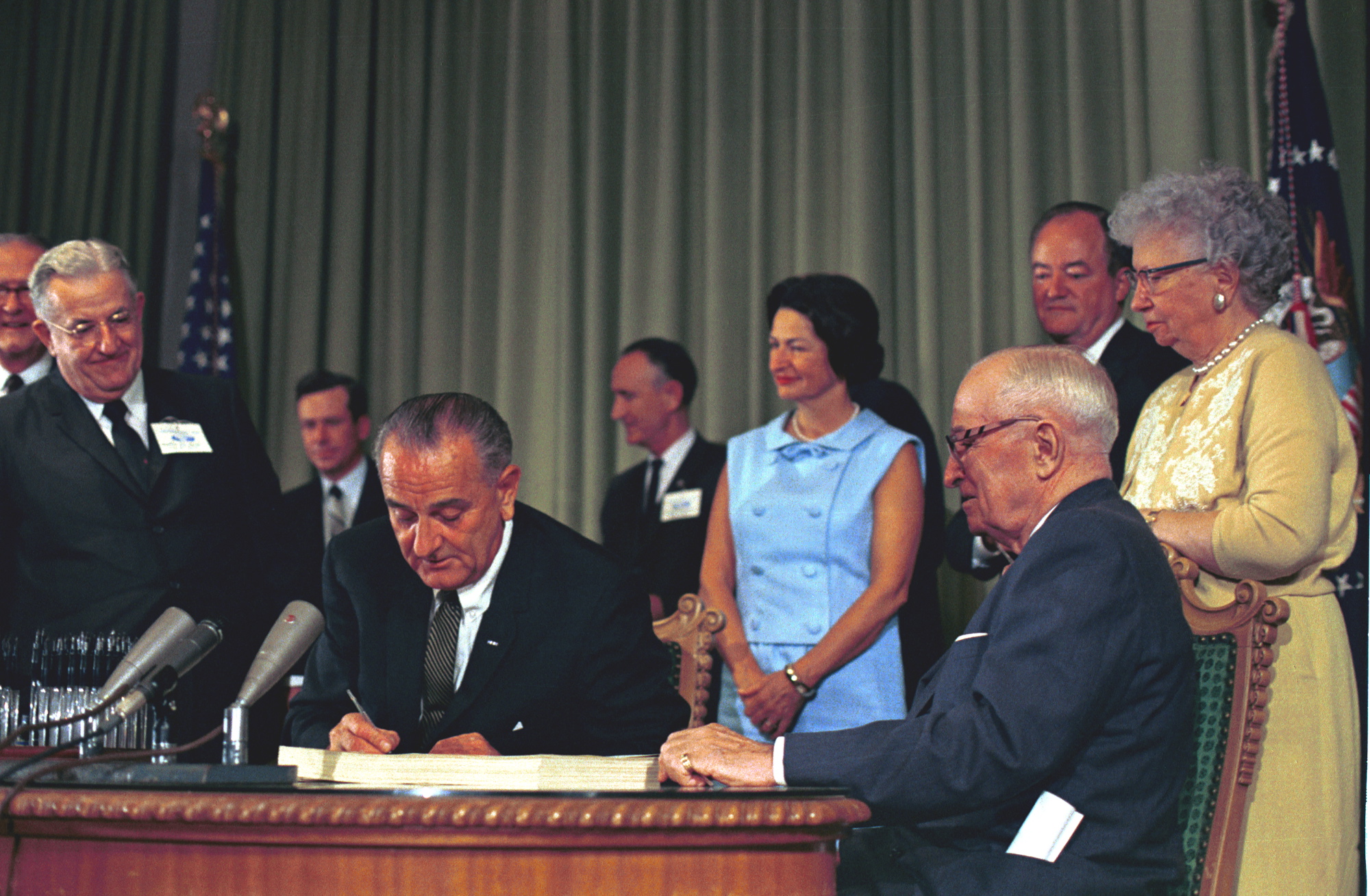 Signing of the Medicare Bill July 30, 1965: Left to right, President Lyndon B. Johnson, Lady Bird Johnson, President Harry S. Truman, Vice President Hubert Humphrey, Bess Truman