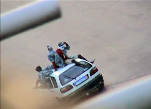 In this frame made from TV, a pro-Incumbent Laurent Gbagbo militia group is seen driving around  in Abidjan, Ivory Coast, Thursday March 31 2011.  Rebels fighting to install Ivory Coast's democratically elected president, Alassane Ouattara ,  began besieging the main city of Abidjan on Thursday as the top army commander fled his post in the face of a lightning offensive that saw several towns and a seaport quickly fall.  (AP Photo / APTN )  TV OUT (AP)