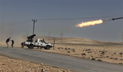 Libyan rebels shell pro Gadhafi positions just outside Brega, Libya, Tuesday, April 5, 2011. Libyan government forces on Tuesday unleashed a withering bombardment of the rebels outside a key oil town pushing them back, even as the regime said Moammar Gadhafi might consider some reforms but would not stepping down.  (AP Photo/Altaf Qadri) (AP)