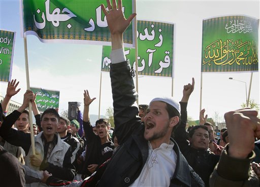 Afghans shout anti- US slogans during a demonstration  in Kabul, Afghanistan on Friday, April  1, 2011.  Eight foreigners were killed on Friday after demonstrators protesting a reported burning of the Muslim holy book stormed a United Nations (UN) office in northern Afghanistan, opening fire on guards and setting fires inside the compound, a top Afghan police official said. Right banner says 'there is no God but Allah and Mohammad is his messenger' and the center banner says 'long live holy Quran'.  (AP Photo/Musadeq Sadeq) (AP)