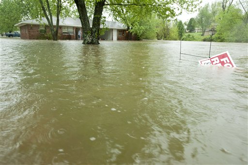 Water from a nearby creek begins to rise around a home on 54th Street on Monday, April 25, 2011, in Fayetteville, Ark. Much of Northwest Arkansas was hit with heavy rain and flash floods. (AP Photo/Beth Hall) (AP)