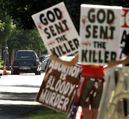 FILE - In this June 6, 2009 file photo, protesters from Rev. Fred Phelps' Westboro Baptist Church demonstrate during funeral services for Dr. George Tiller at College Hill United Methodist Church in Wichita, Kan. In an 8-1 ruling, the U.S. Supreme Court ruled the group's protests were protected by the First Amendment. The father of a Marine killed in Iraq sued after they picketed his son's 2006 funeral service.(AP Photo/Charlie Riedel, File) (AP)