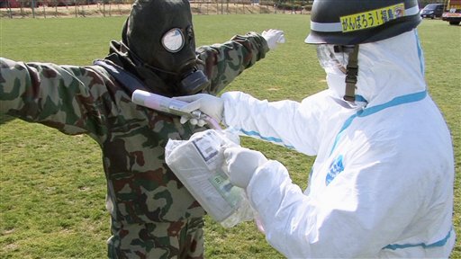 In this April 12, 2011 photo released by the Japan Defense Agency via Kyodo News, a Japanese soldier is tested for radiation exposure at J-Village, a soccer training complex now serving as an operation base for those battling Japan's worst nuclear disaster, northeastern Japan. The sports complex is about about 20 kilometers (12 miles) from the Fukushima Dai-ichi nuclear plant. (AP Photo/Japan Defense Agency via Kyodo News) JAPAN OUT, MANDATORY CREDIT, NO LICENSING IN CHINA, HONG KONG, JAPAN, SOUTH KOREA AND FRANCE (AP)