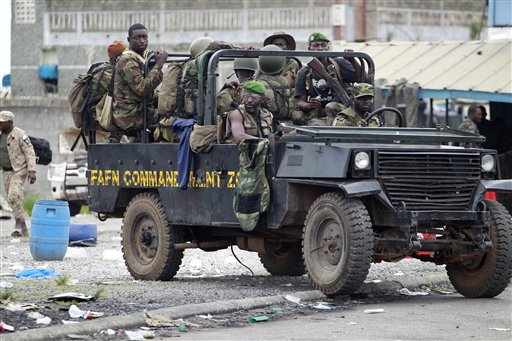 New Forces soldiers loyal to Alassane Ouattara drive at a checkpoint at one of the principal entrances to Abidjan, Ivory Coast, Tuesday, April 5, 2011. Ivory Coast's entrenched strongman Laurent Gbagbo huddled in a bunker at his home and was exploring different options for his surrender, officials said Tuesday, as forces backing the country's democratically elected leader seized the residence.(AP Photo/Rebecca Blackwell) (AP)