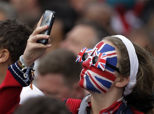A spectator takes a photo outside of Westminster Abbey before the Royal Wedding of Prince William and Kate Middleton in London Friday, April, 29, 2011. (AP Photo/Gero Breloer) (AP)