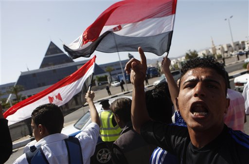 Egyptians shout anti-Mubarak slogans as they demonstrate in front of the hospital where former Egyptian President Hosni Mubarak, 82, is being hospitalized in the Red Sea resort of Sharm el-Sheikh, Egypt, Wednesday, April 13, 2011. Egypt's ousted President Hosni Mubarak was put under detention in his hospital room Wednesday for investigation on accusations of corruption, abuse of power and killings of protesters in a dramatic step Wednesday that brought celebrations from the movement that drove him from office. (AP Photo/Amr Nabil) (AP)