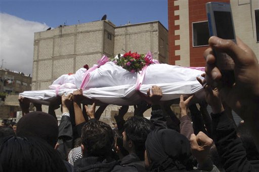 In this citizen journalism image made on a mobile phone and acquired Saturday April 23, 2011,  by The Associated Press, Syrian anti-government protesters carry the coffin of an activist who was killed on Friday during his funeral procession in Quaboun near Damascus, Syria, Saturday, April 23, 2011. Syrian security forces fired on tens of thousands of mourners during funeral processions Saturday, killing several people following the deadliest day of the uprising against authoritarian President Bashar Assad. (AP Photo) (AP)
