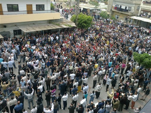In this citizen journalism image made on a mobile phone and acquired by the AP, Syrians gather after Friday prayers during an anti-government protest in the coastal city of Banias, Syria, Friday, April 29, 2011. Thousands of Syrian protesters chanting "We are not afraid!" were met with bullets and tear gas Friday as security forces opened fire, killing more than 40 people. Many of the dead were villagers who tried to break a military blockade in the city at the heart of the six-week uprising, witnesses said. (AP Photo) (AP)