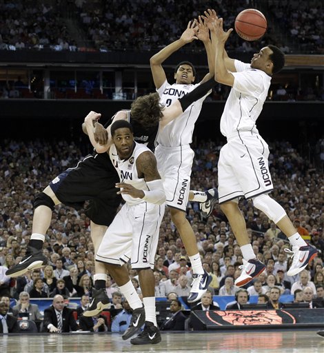 Butler's Matt Howard, left, fights for a rebound with Connecticut's Alex Oriakhi, Jeremy Lamb (3) and Shabazz Napier, right, during the second half of the men's NCAA Final Four college basketball championship game Monday, April 4, 2011, in Houston. (AP Photo/David J. Phillip) (AP)