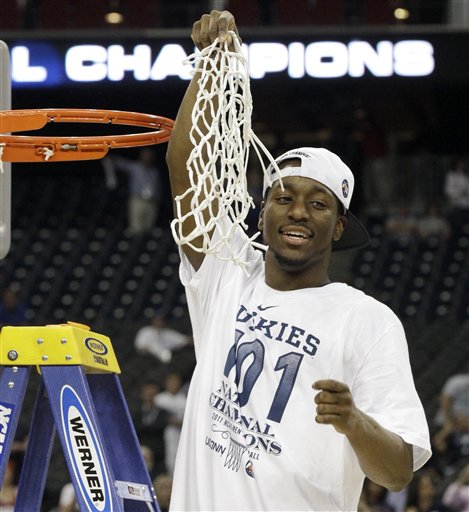 Connecticut's Kemba Walker holds the net after his team won the men's NCAA Final Four college basketball championship game against Butler  53-41 Monday, April 4, 2011, in Houston. (AP Photo/David J. Phillip) (AP)