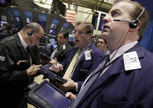 FILE - In this file photo taken March 18, 2011, James Doherty, right, works with fellow traders on the floor of the New York Stock Exchange. Hopes that a U.S. jobs report later will show the world's largest economy is clearly on the mend helped global stocks post solid gains Friday, April 1, 2011, despite ongoing concerns over the situation in Libya. (AP Photo, file) (AP)