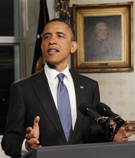 President Obama poses for photographers in the Blue Room at the White House in Washington after he spoke regarding the budget and averted government shutdown after a deal was made between Republican and Democrat lawmakers, Friday, April 8, 2011. (AP Photo/Charles Dharapak) (AP)