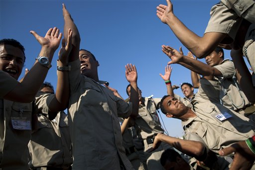 New cadets for the Libyan rebel army dance and chant anti Moammar Gadhafi  slogans before the ceremony graduation in Benghazi, Libya, Sunday, May 29, 2011.   (AP Photo/Rodrigo Abd) (AP)