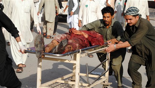 People rush a man injured in a suicide bomb attack  to a local hospital in Peshawar, Pakistan Friday, May 13, 2011. Twin explosions struck a paramilitary training center in northwestern Pakistan on Friday, in the bloodiest attack in the country since a U.S. raid killed al-Qaida chief Osama bin Laden. (AP Photo/Mohammad Zubair) (AP)