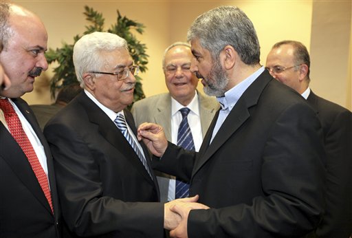 In this photo released by the Hamas Media Office, Palestinian President Mahmoud Abbas, center-left, and Hamas leader Khaled Mashaal, center-right, shake hands at a ceremony in Cairo, Egypt Wednesday, May 4, 2011. Rival Palestinian factions Fatah and Hamas on Wednesday proclaimed a landmark, Egyptian-mediated reconciliation pact aimed at ending their bitter four-year rift, at a declaration ceremony in the Egyptian capital Cairo. (AP Photo/Hamas Media Office) ** EDITORIAL USE ONLY, NO SALES ** (AP)