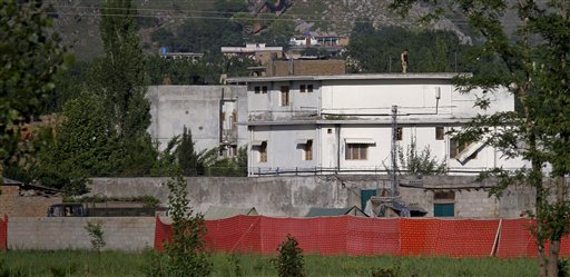 FILE - In this May 2, 2011 file photo, a Pakistan army soldier stands on top of the house where it is believed al-Qaida leader Osama bin Laden lived in Abbottabad, Pakistan. The Americans who raided Osama bin Laden's lair met far less resistance than the Obama administration described in the aftermath, according to its latest account. The commandos encountered gunshots from only one man, whom they quickly killed, before sweeping the house and shooting others, who were unarmed, a senior defense official said. (AP Photo/Anjum Naveed, File) (AP)