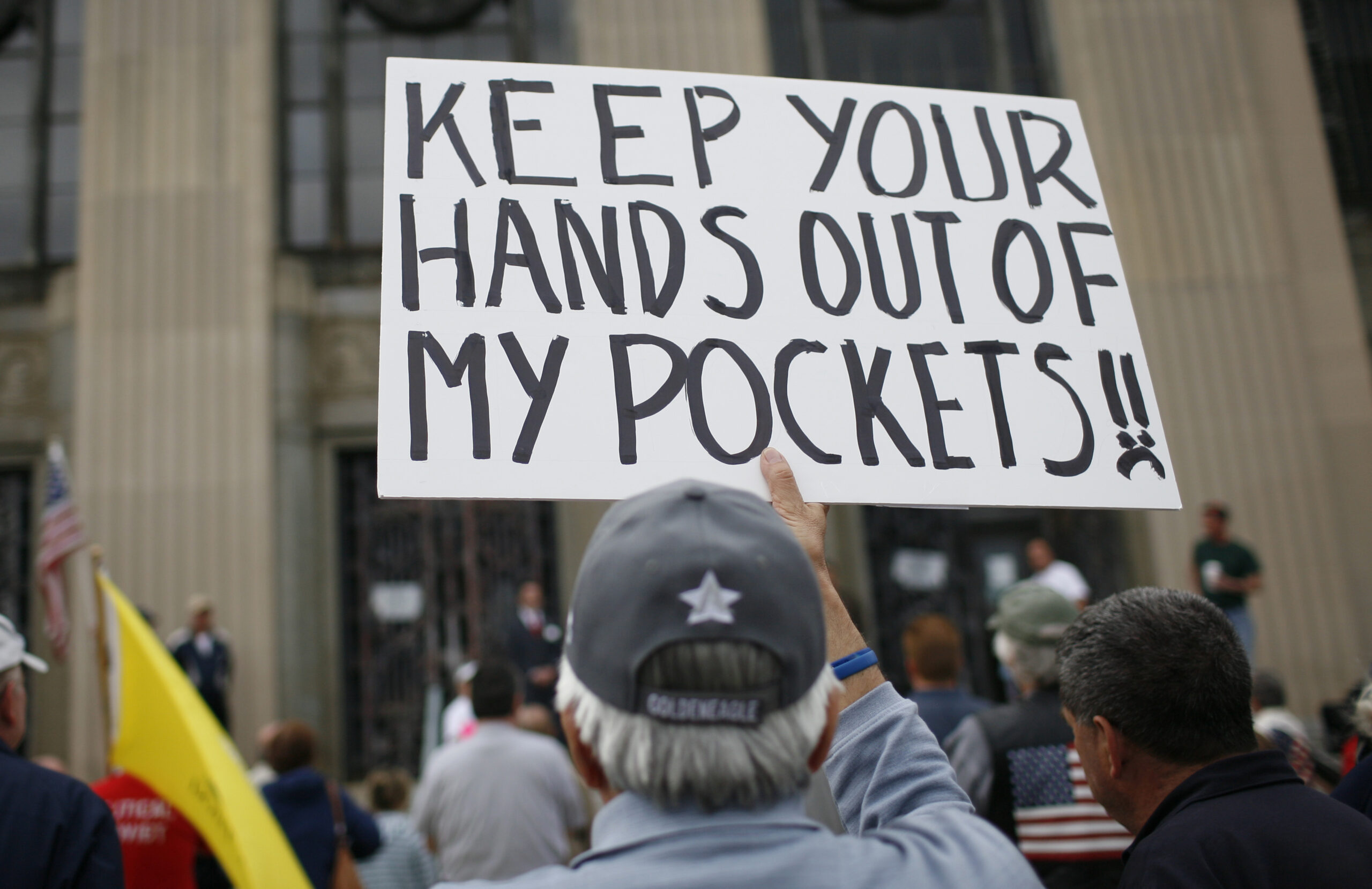 A man holds a sign at a tax day rally by Tea Party activists in the New York City suburb of New City, New York, April 15, 2010. April 15 is the deadline for filing tax returns in the U.S.   REUTERS/Mike Segar   (UNITED STATES - Tags: BUSINESS POLITICS) (Reuters)