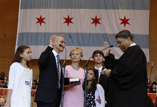 Rahm Emanuel takes the oath of office of Mayor of Chicago from Timothy C. Evans, Chief Judge of the Circuit Court of Cook County during inaugural ceremonies Monday, May 16, 2011 in Chicago. Watching are from left, daughter Ilana, wife Amy Rule, daughter Leah and son Zacharia. (AP Photo/Charles Rex Arbogast) (AP)