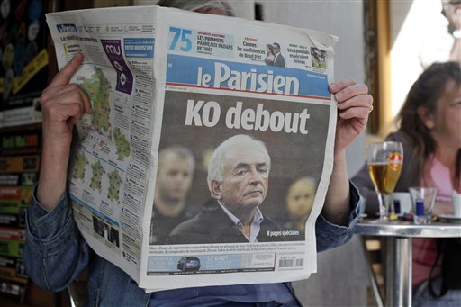 A woman reads the French newspaper "Le Parisien" headlining on IMF head arrest, in Paris, Tuesday May 17, 2011. Allegations of sexual assault in a New York hotel have torn France's presidential race asunder and savaged the reputation of the suave and self-assured Dominique Strauss-Kahn, chief of the International Monetary Fund. The 62-year-old Strauss-Kahn has topped French opinion polls for months as the man most likely to become this nation's next president, consistently outshining the little-loved conservative incumbent, Nicolas Sarkozy. Headline reads: Standing K.O. (AP Photo/Thibault Camus) (AP)