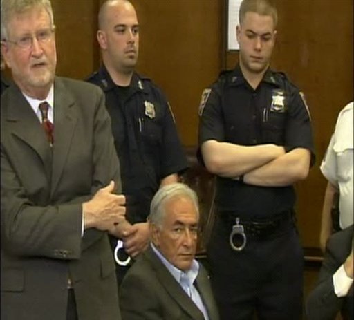 This frame grab taken from pool video shows former IMF leader Dominique Strauss-Kahn, center, seated, as he appears at a court hearing in the Manhattan borough of New York, Thursday May 19, 201, surrounded by his lawyer William Taylor, left, and unidentified police officers. Strauss-Kahn made a new bid to get released from jail while he awaits trial on charges that he sexually abused a hotel maid. A prosecutor began the hearing by announcing that a grand jury had found enough evidence for an indictment, a procedural step that elevates the seriousness of the charge. (AP Photo/NBC, Pool) (AP)