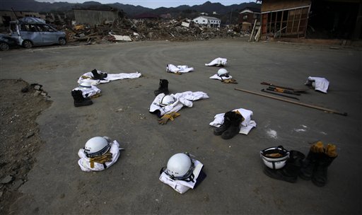 Police officers' protective suits, boots and helmets are placed on the ground while they rest after their recovery operation shift in the area destroyed by the March 11 earthquake and tsunami in Kesennuma,  Miyagi Prefecture, northeastern Japan, Saturday, May 7, 2011.  (AP Photo/Junji Kurokawa) (AP)