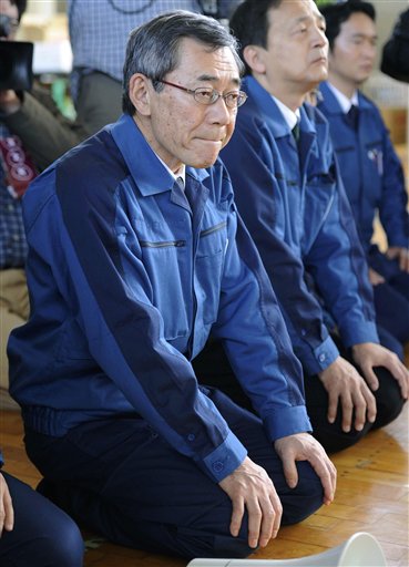 FILE - In this May 4, 2011 file photo, Tokyo Electric Power Co. President Masataka Shimizu, front, listens to Namie villagers at an evacuation center at Nihonmatsu in Fukushima prefecture.    Japanese media reports Friday, May 20, 2011, said Tokyo Electric Power Co. President Shimizu will resign to take responsibility for the nuclear crisis at the Fukushima Dai-ichi power complex in northeastern Japan.  (AP Photo/Kyodo News, File) JAPAN OUT, MANDATORY CREDIT, NO LICENSING IN CHINA, HONG KONG, JAPAN, SOUTH KOREA AND FRANCE (AP)