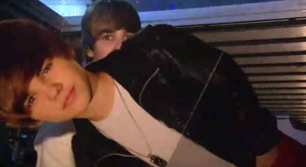 Justin hiding out behind a cardboard cutout in "Never Say Never."