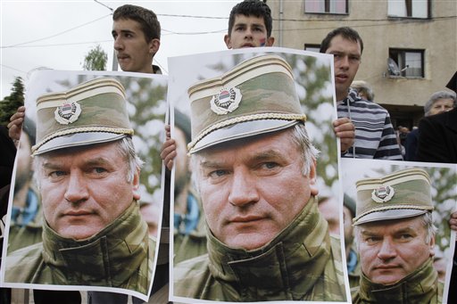 Bosnian Serb people holding photos of former Gen. Ratko Mladic during a protest in Kalinovik, Bosnia, hometown of the Bosnian Serb wartime military leader, 70 kms southeast of Sarajevo, Sunday, May 29, 2011. Approximately 3,000 Bosnian Serbs, gathered to show support and anger after the arrest of Mladic. Protestors carried banners and flags and sang songs in his support, he was arrested after 16 years in hiding from the International War Crimes Tribunal in the Hague. Mladic is to face trial on 15 accounts of war crimes including genocide in Srebrenica in 1995. (AP Photo/Amel Emric) (AP)