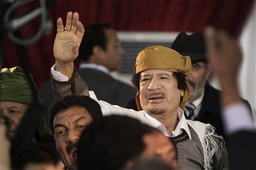FILE - In this March 2, 2011 file photo, Libyan Leader Moammar Gadhafi waves to supporters as he arrives to speak in Tripoli, Libya. Moammar Gadhafi says he's alive after NATO attacks and has support of millions of Libyans. (AP Photo/Ben Curtis, File) (Associated Press)