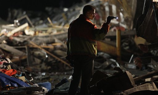 An emergency worker searches a Walmart store that was severely damaged by a tornado in Joplin, Mo., Sunday, May 22, 2011. A large tornado moved through much of the city, damaging a hospital and hundreds of homes and businesses. (AP Photo/Charlie Riedel) (AP)