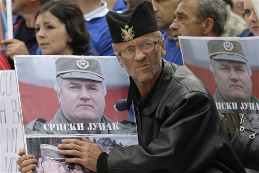 A Bosnian Serb man holds a photo of former Gen. Ratko Mladic during a protest in Kalinovik, Bosnia, hometown of the Bosnian Serb wartime military leader, 70 kms southeast of Sarajevo, Sunday, May 29, 2011. Approximately 3,000 Bosnian Serbs, gathered to show support and anger after the arrest of Mladic. Protestors carried banners and flags and sang songs in his support, he was arrested after 16 years in hiding from the International War Crimes Tribunal in the Hague. Mladic is to face trial on 15 accounts of war crimes including genocide in Srebrenica in 1995. (AP Photo/Amel Emric) (AP)