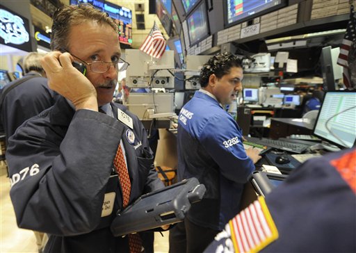 FILE - In this file photo taken May 6, 2011, traders work on the floor of the New York Stock Exchange, in New York. World share markets sank Thursday, May 12, 2011, after a slide on Wall Street sparked by tumbling demand for oil and fears of slackening growth in the U.S.(AP Photo/Henny Ray Abrams, file) (AP)
