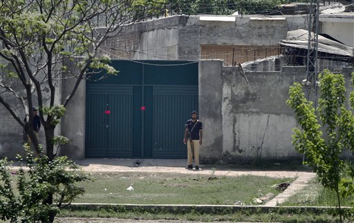 Pakistani police officers stand guard at the main gate of a house where al-Qaida leader Osama bin Laden was caught and killed in Abbottabad, Pakistan on Wednesday, May 4, 2011. The residents of Abbottabad, Pakistan, were still confused and suspicious on Wednesday about the killing of Osama bin Laden, which took place in their midst before dawn on Monday. (AP Photo/Anjum Naveed) (AP)