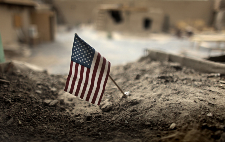 An American flag is placed in a dirt-filled barrier outside the headquarters of 3rd Platoon, 1-320 Field Artillery Regiment, 101st Airborne Divivion, at Combat Outpost Nolen in the Arghandab Valley north of Kandahar July 22, 2010.
