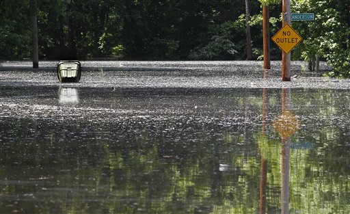 High water cover the road in the Box Town neighborhood as a waste can floats Sunday, May 8, 2011 in Memphis, Tenn. as flood waters continue to rise along the Mississippi River. (AP Photo/Wade Payne) (AP)